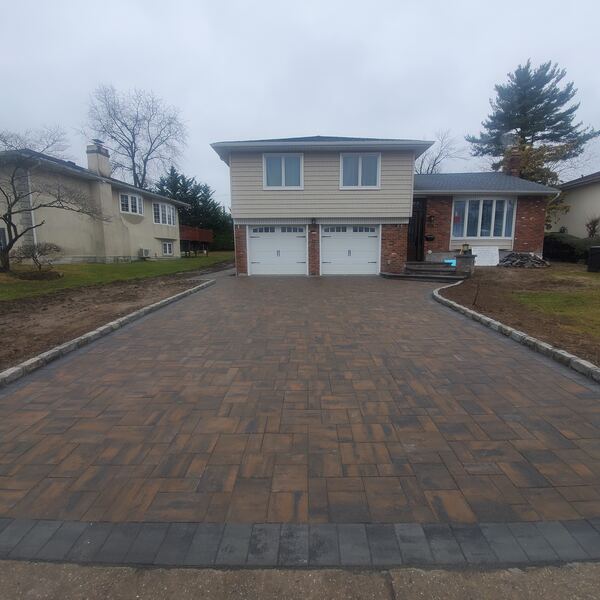 Elegant herringbone paver driveway with decorative border
