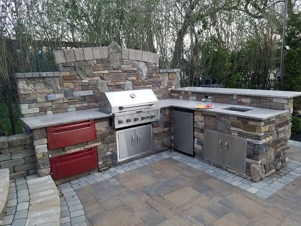Outdoor kitchen island with bar seating area