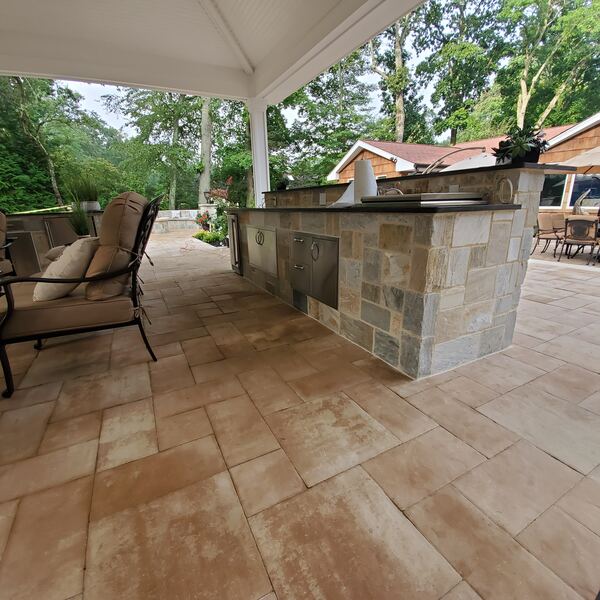Outdoor kitchen with natural stone finish and storage