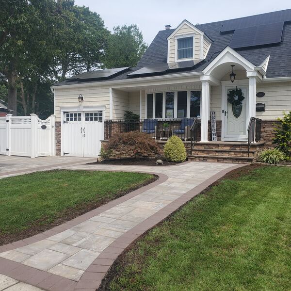 Curved paver walkway through landscaped garden